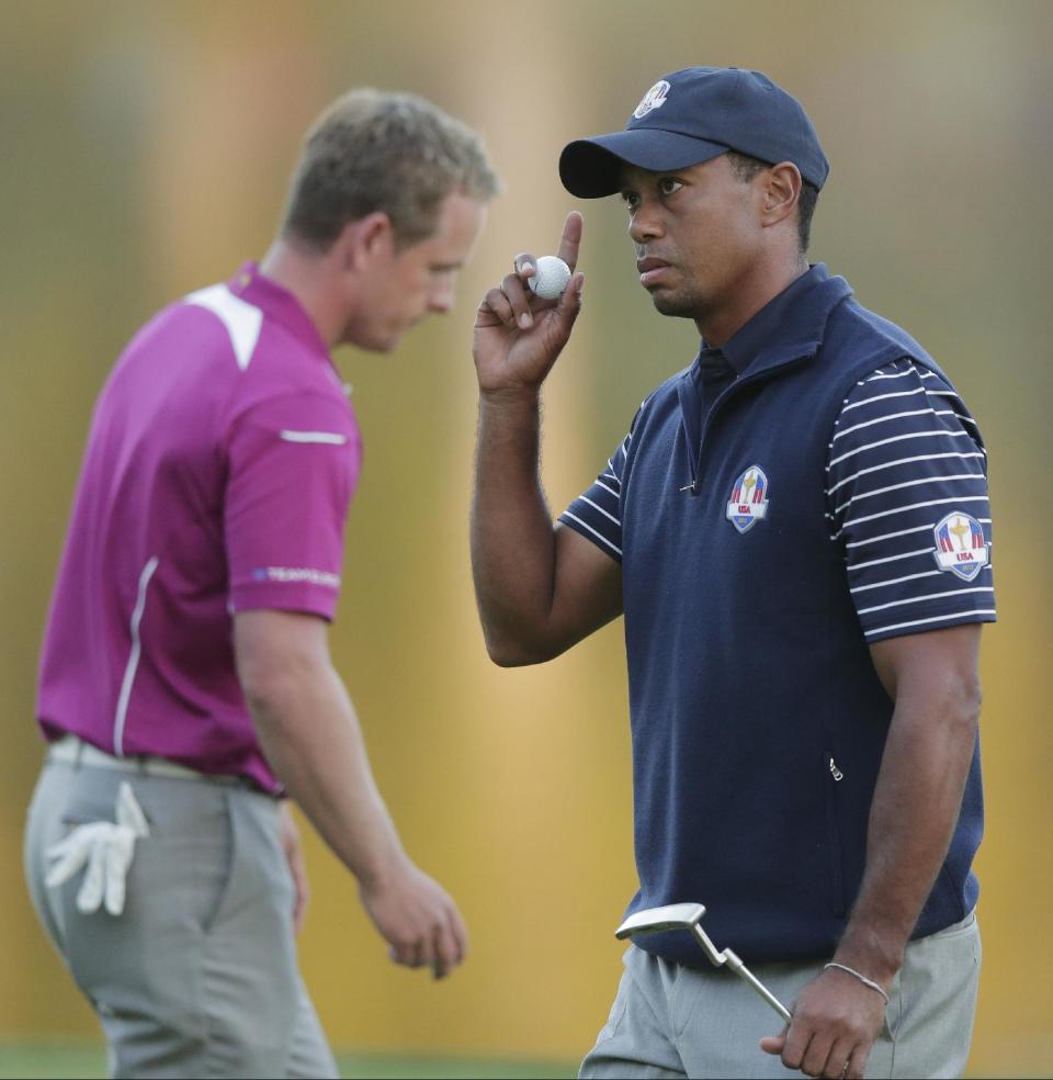 USA's Tiger Woods reacts after making a putt on the 17th hole during a four-ball match at the Ryder Cup PGA golf tournament Saturday, Sept. 29, 2012, at the Medinah Country Club in Medinah, Ill. (AP Photo/Charlie Riedel)