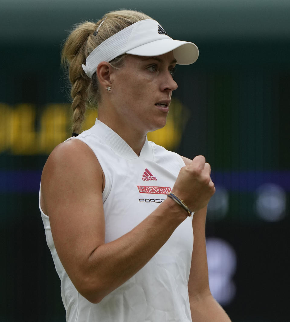 Germany's Angelique Kerber celebrates winning a point against Czech Republic's Karolina Muchova during the women's singles quarterfinals match on day eight of the Wimbledon Tennis Championships in London, Tuesday, July 6, 2021.(AP Photo/Alastair Grant)