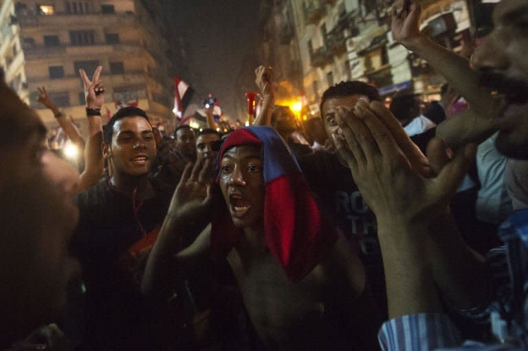 People celebrate in Cairo's Tahrir Square after the toppling of President Mohammed Morsi on July 3, 2013