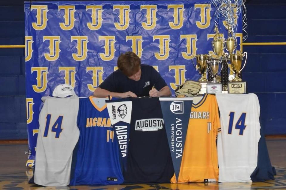 Ty Cobb signs a scholarship agreement to play baseball with the Augusta University Jaguars.