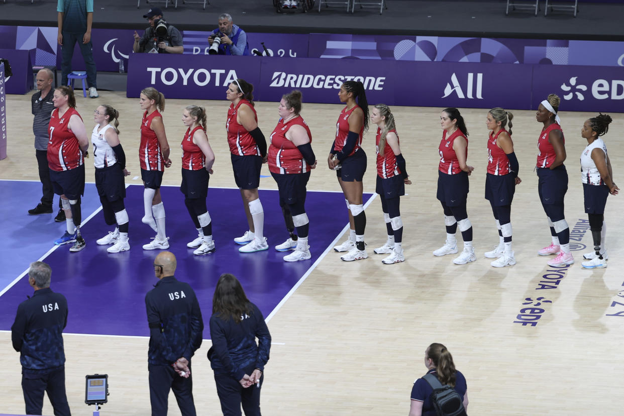 The U.S. women's sitting volleyball team stands as their national anthem plays prior to the semifinal beginning at the North Paris Arena at the 2024 Paralympics, Thursday, Sept. 5, 2024. (AP Photo/Kileigh Kane)