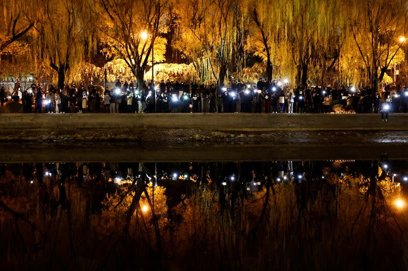 FILE PHOTO: Vigil commemorating victims of a fire in Urumqi, in Beijing