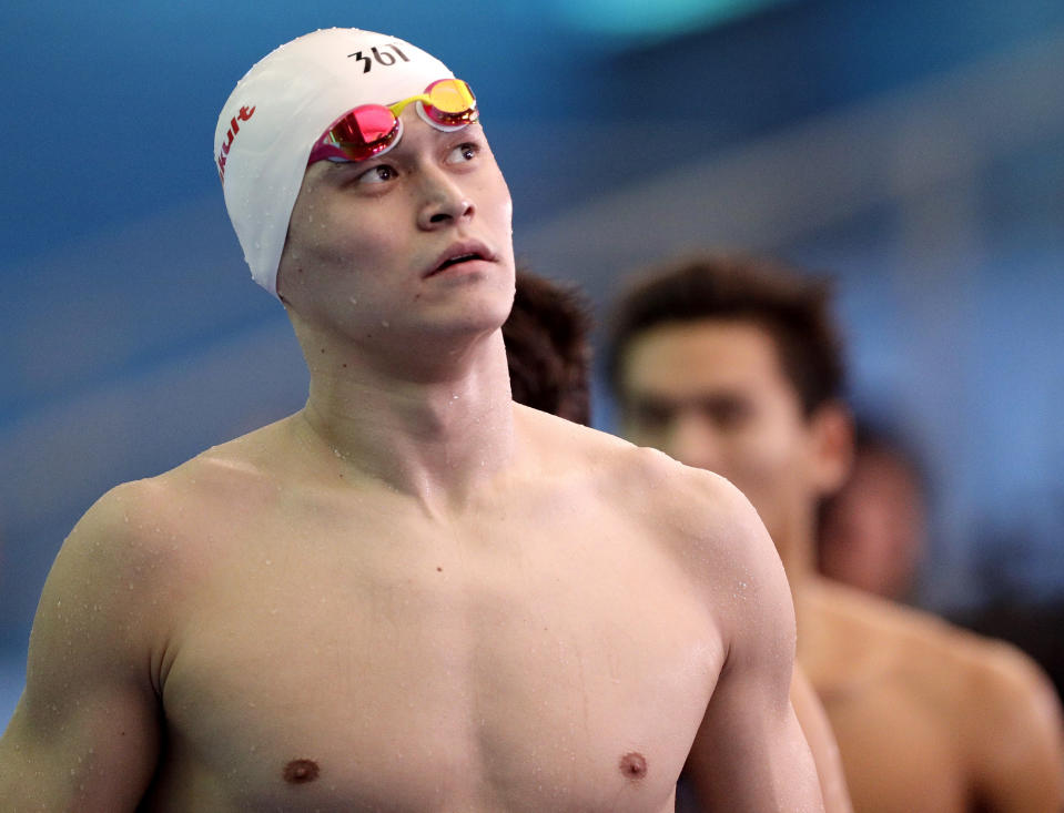 FILE - In this July 26, 2019, file photo, China's Sun Yang leaves the pool deck following the men's 4x200m freestyle relay heats at the World Swimming Championships in Gwangju, South Korea. Chinese swimmer star Sun Yang has been banned for more than four years for breaking anti-doping rules. The verdict by the Court of Arbitration for Sport ends Sun’s hopes of defending his Olympic title in the 200 meters freestyle in Tokyo next month. His ban expires in May 2024. (AP Photo/Mark Schiefelbein, File)