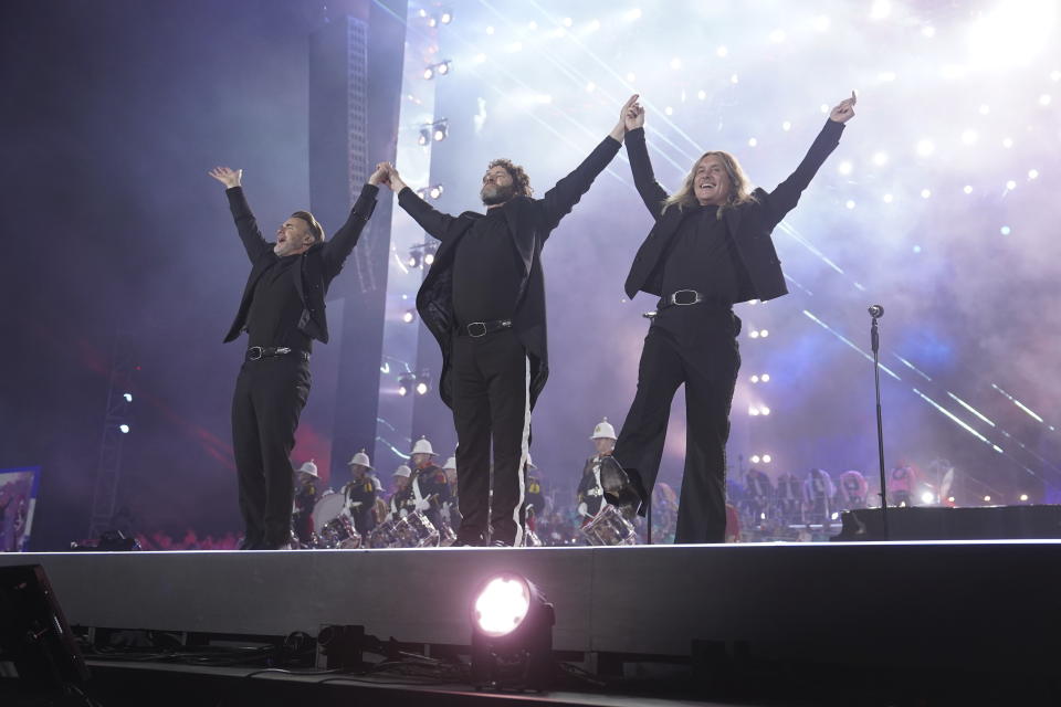 Gary Barlow, Howard Donald and Mark Owen of Take That perform during a concert at Windsor Castle in Windsor, England, Sunday, May 7, 2023, celebrating the coronation of King Charles III. It's one of several events over a three-day weekend of celebrations. (Arthur Edwards/The Sun via AP, Pool)