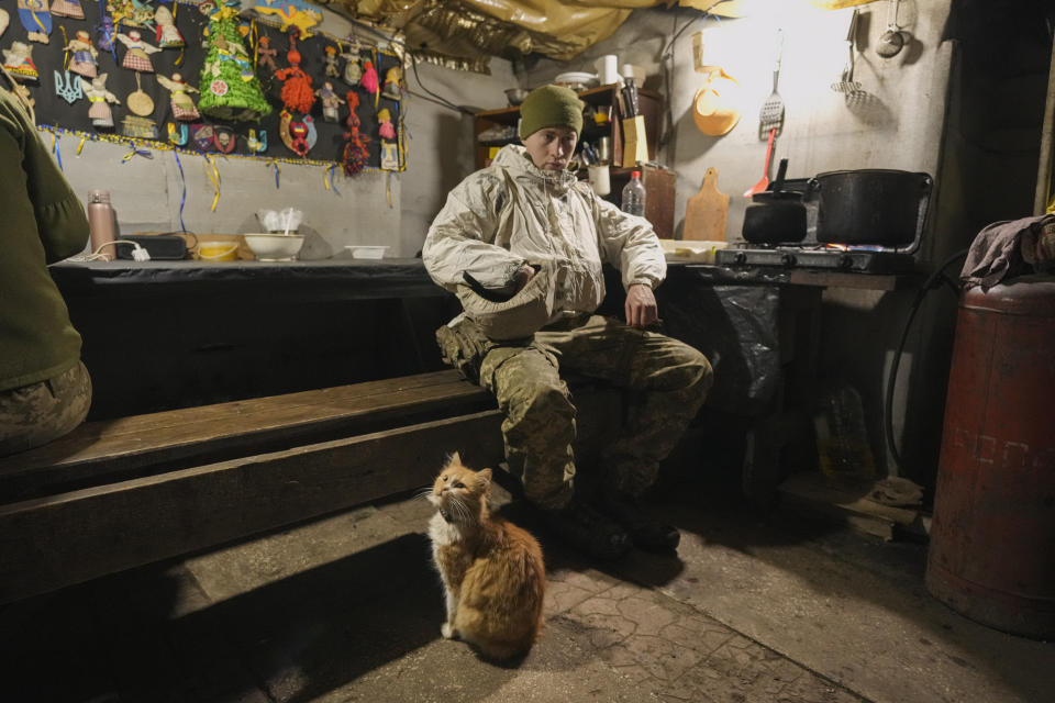 Good luck charms are pinned to a wall as a Ukrainian serviceman pauses in a bunker on a frontline position outside Avdiivka, Donetsk region, eastern Ukraine, Friday, Feb. 4, 2022. While waves of Ukrainians fled their homes during 2014 fighting that saw Russia annex the Crimean Peninsula and back separatists in the eastern province of Donbas, so far people are staying put in the areas closest to the Russian troop movements. (AP Photo/Vadim Ghirda)