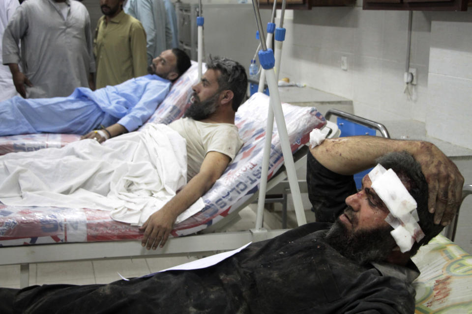 Injured victims of bomb blast are treated at a hospital, in Saidu Sharif, in Pakistan's Swat Valley, Monday, April 24, 2023. Two explosions Monday at a counterterrorism police facility in northwest Pakistan killed several people and wounded dozens, police said. (AP Photo/Naveed Ali)