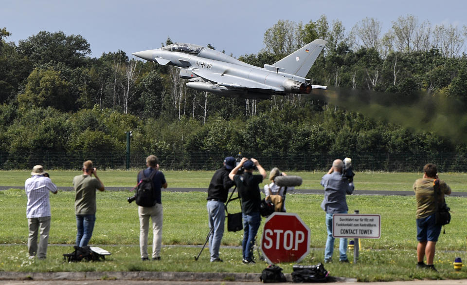 Journalists watch the take off of a German Eurofighter jet at the airbase in Noervenich, Germany, Thursday, Aug. 20, 2020. Pilots from Israel and Germany will fly together the next two weeks during the first joint military Air Force exercises between the two nations in Germany. (AP Photo/Martin Meissner)