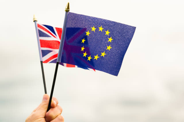 A small Union Flag of the United Kingdom, held together with a European Union flag, representing the choice in the British refer