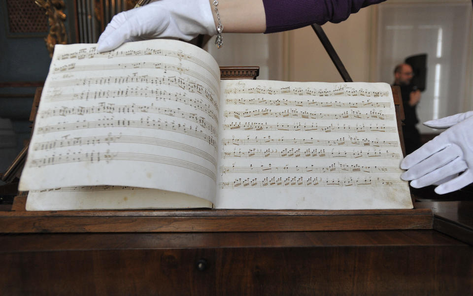 Sheets of music, recently identified as a composition by Wolfgang Amadeus Mozart, are presented during a press conference held by the research department of the International Mozarteum Foundation in Salzburg, Austria, Friday, March 23, 2012. The previously unknown piano piece from Mozart was discovered in Tyrol in Austria. The Mozart Foundation in Salzburg says that the piece was found in a hand written music book from 1780. (AP Photo/ Kerstin Joensson)