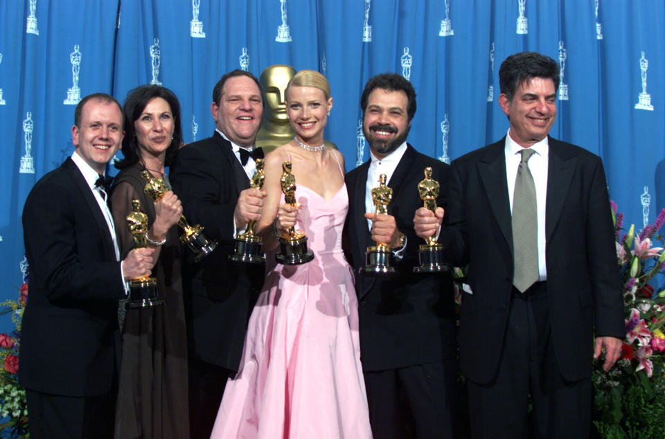 LOS ANGELES, CALIFORNIA - MARCH 21 : "Shakespeare in Love' Best Actress winner Gwyneth Paltrow (center) is joined by Harvey Weinstein (center lett) David Parfitt (left), Donna Gigliotti,Edward Zwick and Marc Norman (right) backstage as they celebrated their win of Best Picture at the 1999 Academy Awards in Hollywood, California, March 21, 1999.(Photo by Bob Riha, Jr./Getty Images)