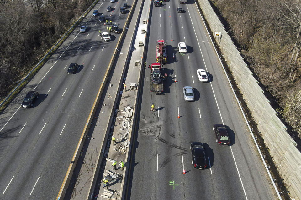 Image: Emergency personnel work at the scene of a fatal crash along Interstate 695 on March 22, 2023, near Woodlawn, Md. (Julio Cortez / AP)