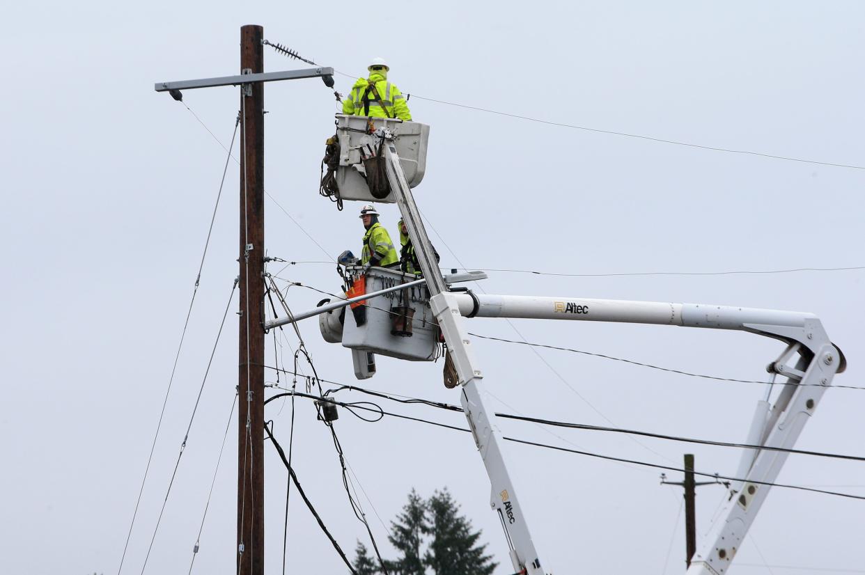 Crews work to restore power to the community of Creswell on Jan. 18 during a power during during a severe winter and ice storm.