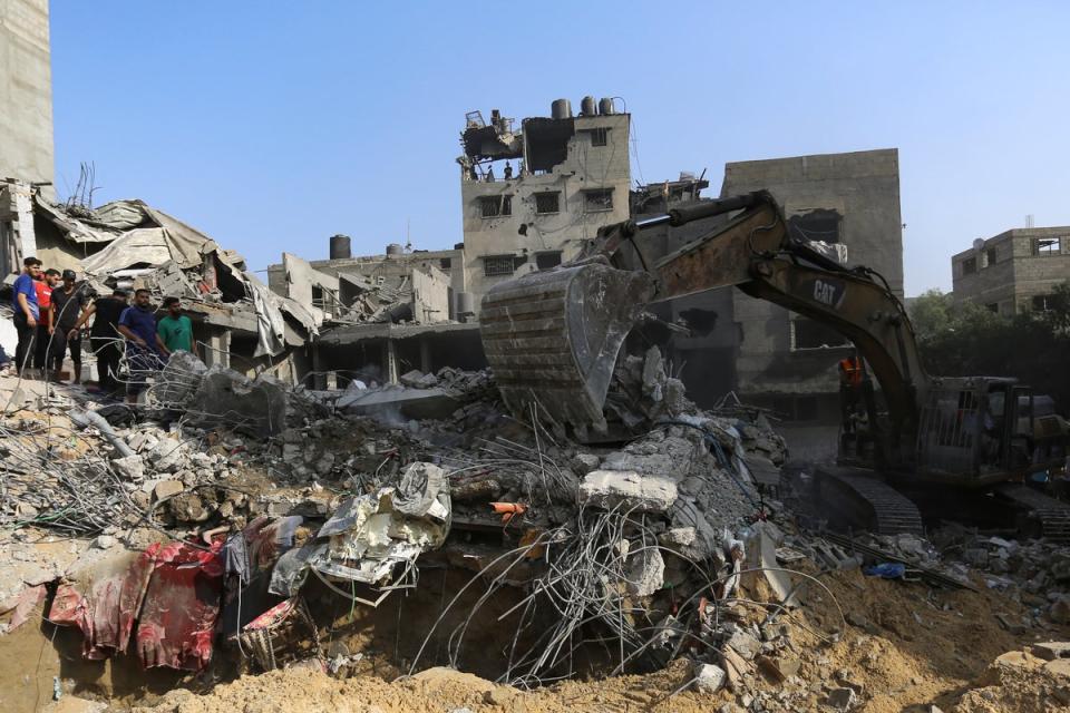 Palestinians inspect the damage of destroyed houses after Israeli airstrikes on Gaza City (Copyright 2023 The Associated Press. All rights reserved.)