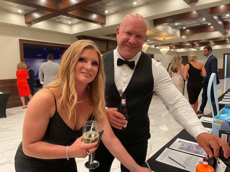 Angela Payne and husband Ottie Payne support Hardin Valley Academy athletics by making a bid on a silent auction item at the first HVAAC Gala held at Bridgewater Place Saturday, Aug. 27, 2022.