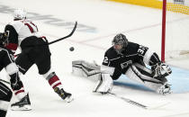 Arizona Coyotes center Tyler Pitlick, left, tries to get a shot past Los Angeles Kings goaltender Jonathan Quick during the first period of an NHL hockey game Wednesday, March 3, 2021, in Los Angeles. (AP Photo/Mark J. Terrill)