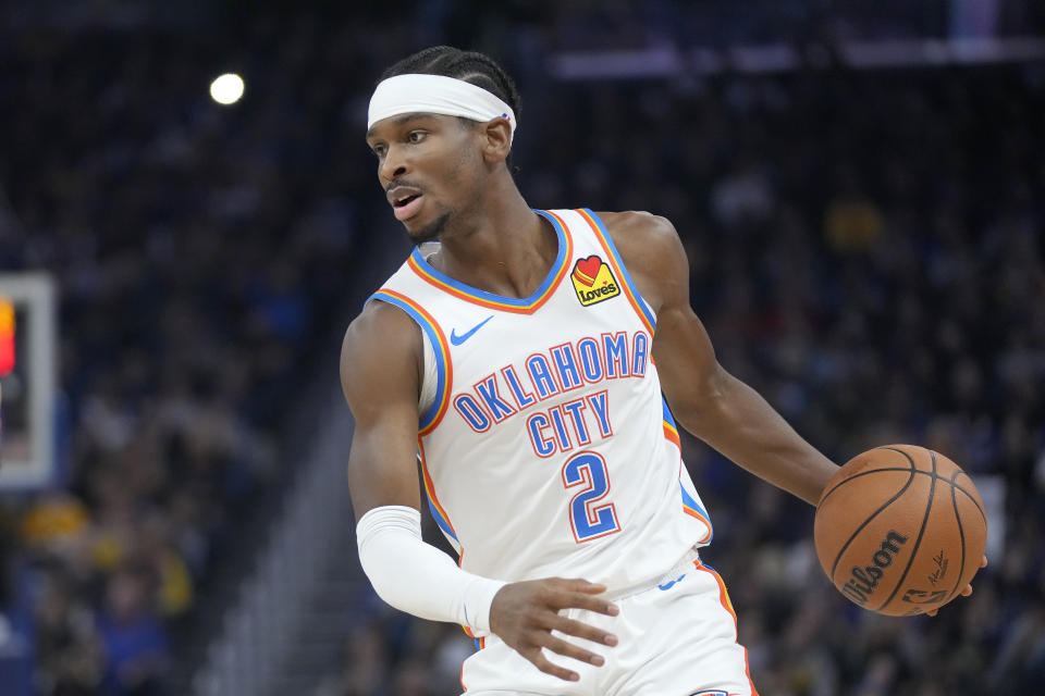 Oklahoma City Thunder guard Shai Gilgeous-Alexander (2) brings the ball up the court against the Golden State Warriors during the first half of an NBA basketball game in San Francisco, Saturday, Nov. 18, 2023. (AP Photo/Jeff Chiu)