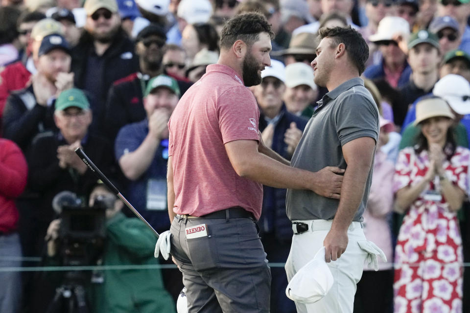 Jon Rahm, of Spain, embraces Brooks Koepka on the 18th hole as Rahm won the final round of the Masters golf tournament at Augusta National Golf Club on Sunday, April 9, 2023, in Augusta, Ga. (AP Photo/Mark Baker)