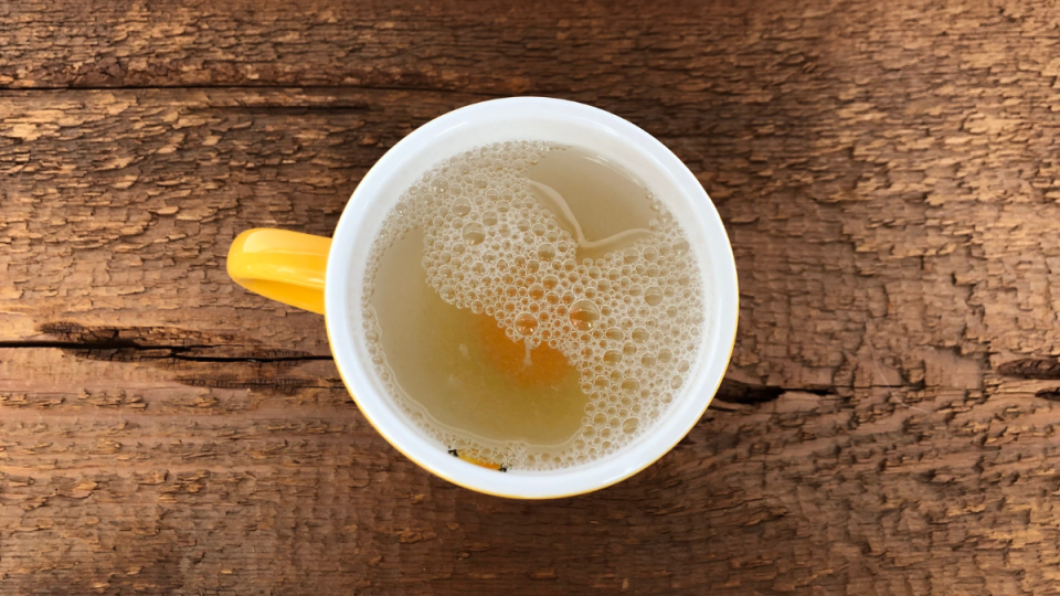 uncooked egg in a small yellow mug