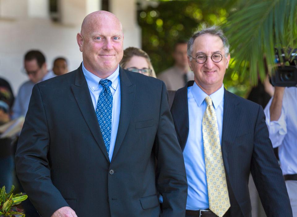 Former Boynton Beach police officer Michael Brown, left, leaves Federal Court with his attorney, Bruce Reinhart, after being sentenced to three years probation, 150 community service and 180 days electronic monitoring Tuesday, February 27, 2018. (Lannis Waters / The Palm Beach Post)