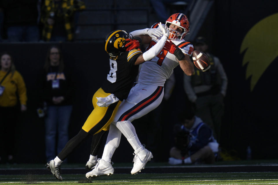 Iowa defensive back Deshaun Lee (8) breaks up a pass intended for Illinois tight end Tip Reiman (89) during the first half of an NCAA college football game, Saturday, Nov. 18, 2023, in Iowa City, Iowa. (AP Photo/Charlie Neibergall)