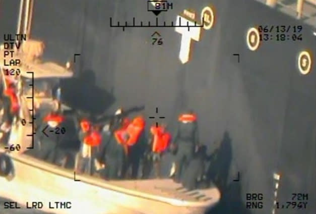 A U.S. military image released by the Pentagon in Washington on June 17, which is says was taken from a U.S. Navy MH-60R helicopter in the Gulf of Oman in waters between Gulf Arab states and Iran on June 13, shows personnel that the Pentagon says are members of the Islamic Revolutionary Guard Corps Navy removing an unexploded limpet mine from the M/T Kokuka Courageous, a Japanese owned commercial motor tanker. Picture taken June 13, 2019.  U.S. Navy/Handout via REUTERS   ATTENTION EDITORS-THIS IMAGE HAS BEEN SUPPLIED BY A THIRD PARTY.