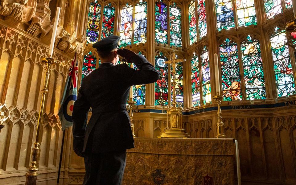 Flying Officer James Buckingham salutes the Battle of Britain memorial window inside Westminster Abbey during a service to mark the 80th anniversary of the Battle. The stained-glass window, by Hugh Easton, contains the badges of the fighter squadrons that took part in the Battle - SAC Connor Tierney/RAF