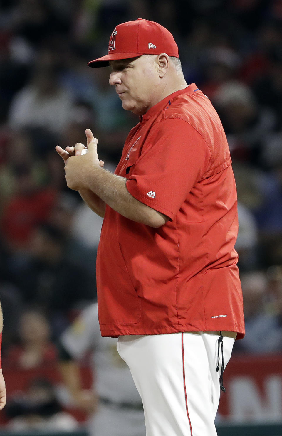 Los Angeles Angels manager Mike Scioscia waits on the mound during a pitching change in the fourth inning of the team's baseball game against the Oakland Athletics on Saturday, Sept. 29, 2018, in Anaheim, Calif. (AP Photo/Marcio Jose Sanchez)