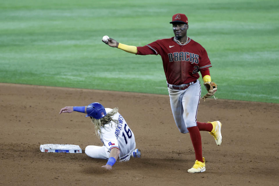 Arizona Diamondbacks shortstop Geraldo Perdomo (2) starts a double play as Texas Rangers' Travis Jankowski (16) slides into second to end the fifth inning of a baseball game, Tuesday, May 2, 2023, in Arlington, Texas. (AP Photo/Michael Ainsworth)