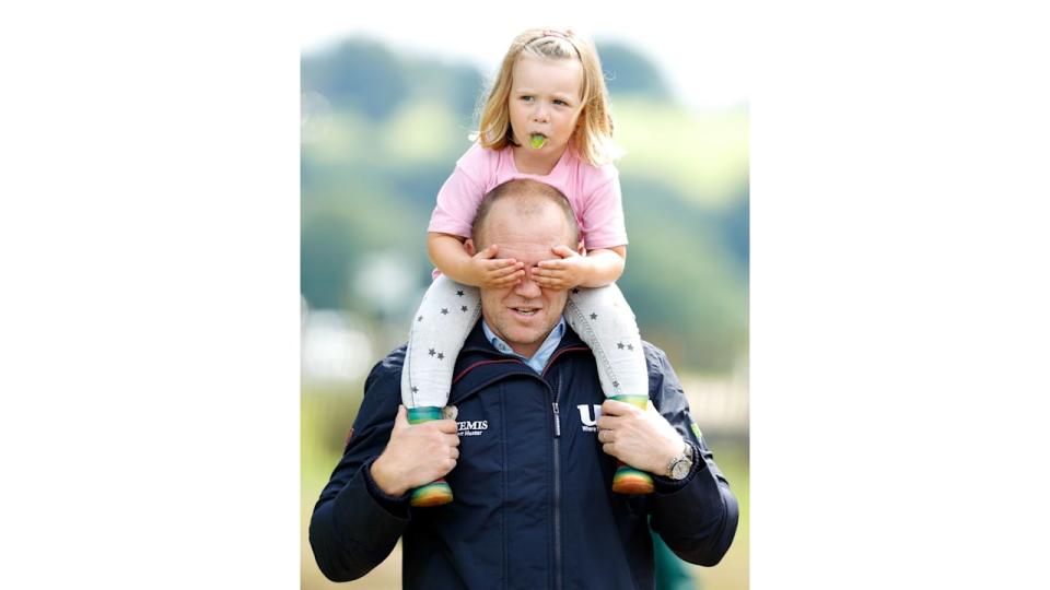 Mia Tindall covering Mike Tindall's eyes while riding on his shoulders