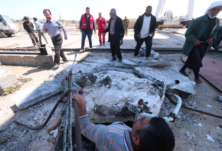 Engineers inspect the damage at the northern part of the Tabqa Dam on the Euphrates river, Syria March 29, 2017. REUTERS/Rodi Said