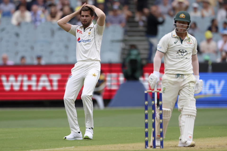 Pakistan's Shaheen Shah Afridi, left, holds his head after seeing Australia's David Warner is dropped of his bowling during their cricket test match in Melbourne, Tuesday, Dec. 26, 2023. (AP Photo/Asanka Brendon Ratnayake)