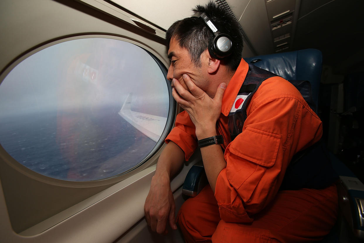 A member of the Japanese coastguard surveys the Indian Ocean in search that was called off in January: Getty