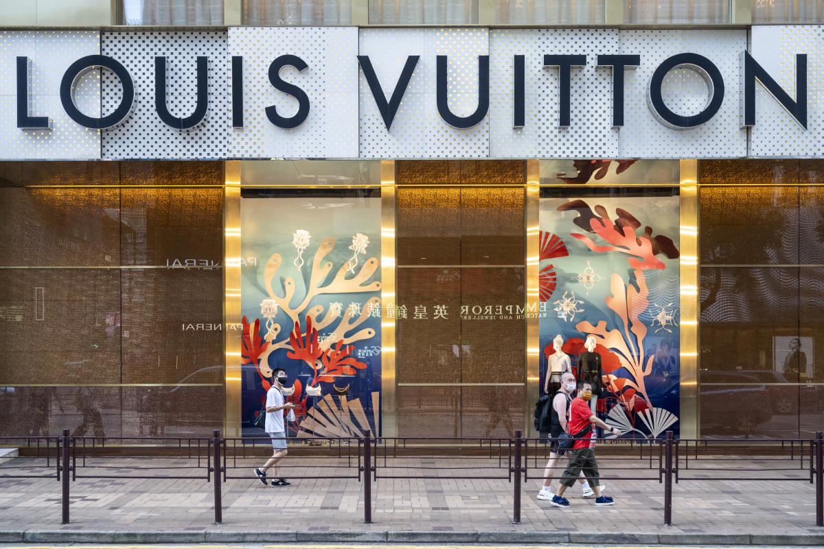 Shoppers walk past the French luxury fashion brand Longchamp store