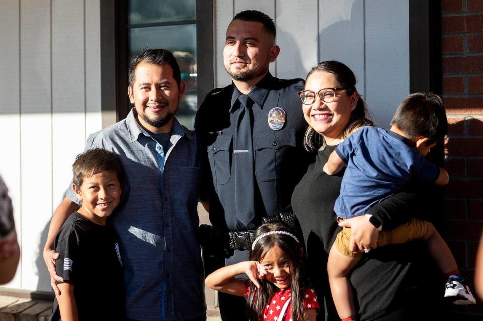 Gustine Police Department Reserve Officer Emanuel Gonzalez, center, poses for photos following a swearing in ceremony for four new Gustine Police Department Reserve Officers in Gustine, Calif., on Tuesday, June 20, 2023. Andrew Kuhn/akuhn@mercedsun-star.com