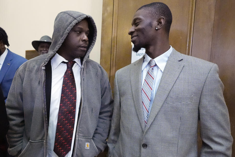 Michael Corey Jenkins, right, and Eddie Terrell Parker, two victims of racially motivated torture by six former Mississippi law enforcement officers, confer following the sentencing in state court of the former lawmen for their roles in the 2023 assault, Wednesday, April 10, 2024, in Brandon, Miss. Time served for the state convictions will run concurrently with the federal sentences, and the men will serve their time in federal penitentiaries. (AP Photo/Rogelio V. Solis)