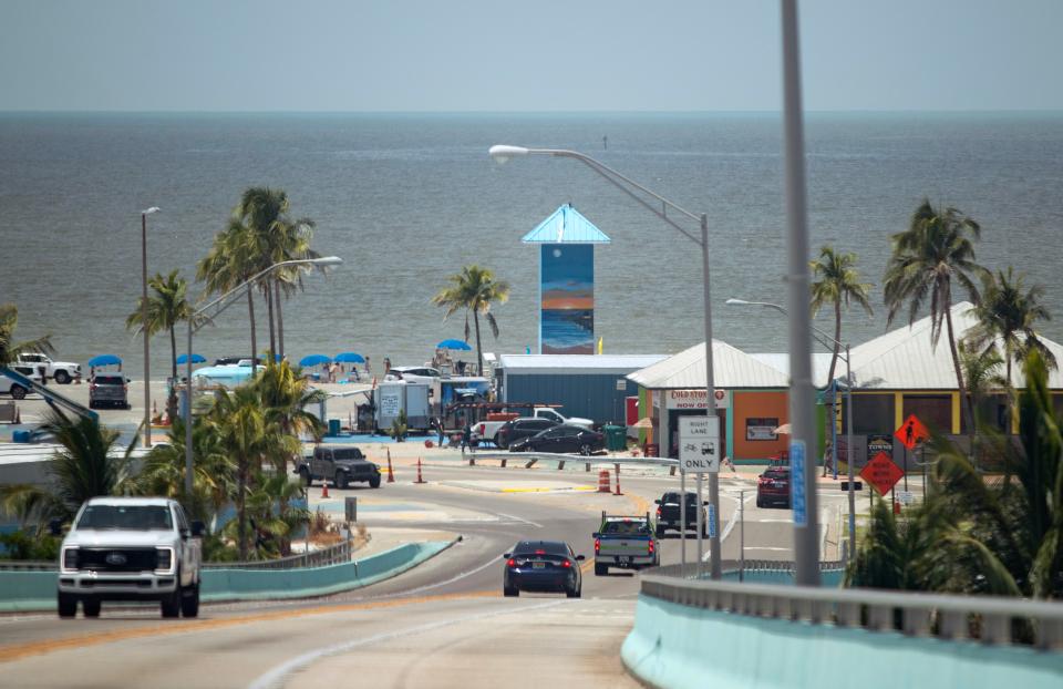 A mural painted by artist Summer DeSalvo can be seen from the Fort Myers Beach bridge on Monday, July 24, 2023. The mural is on the three-story elevator shaft left standing after Hurricane Ian in Times Square.
