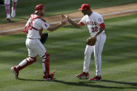 Los Angeles Angels relief pitcher Raisel Iglesias, right, celebrates with catcher Drew Butera after the team's 2-1 win over the Los Angeles Dodgers in a baseball game in Anaheim, Calif., Sunday, May 9, 2021. (AP Photo/Alex Gallardo)