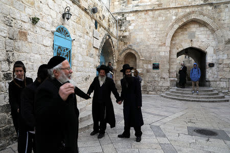 Ultra-Orthodox Jews stand outside the Cenacle, a hall revered by Christians as the site of Jesus' Last Supper, which is located above the traditional site of biblical King David's tomb, in Mount Zion near Jerusalem's Old City January 24, 2019. REUTERS/Ammar Awad