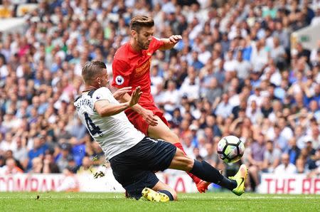 Football Soccer Britain - Tottenham Hotspur v Liverpool - Premier League - White Hart Lane - 27/8/16 Liverpool's Adam Lallana has his shot blocked by Tottenham's Toby Alderweireld Reuters / Dylan Martinez Livepic