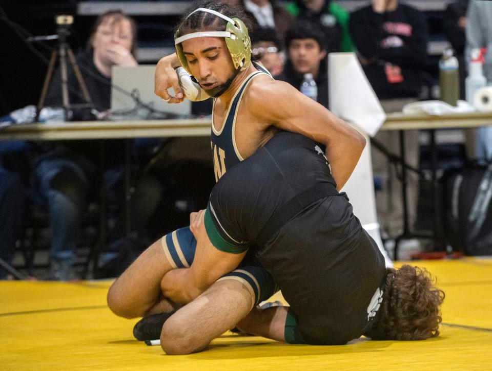 West's Micha Viloria, left, grapples with Ponderosa's Julian Sanchez in the boys 120-lb weight class of the Sac-Joaquin Section Masters Wrestling Tournament at the Adventist Health arena in downtown Stockton on Feb. 16, 2024.