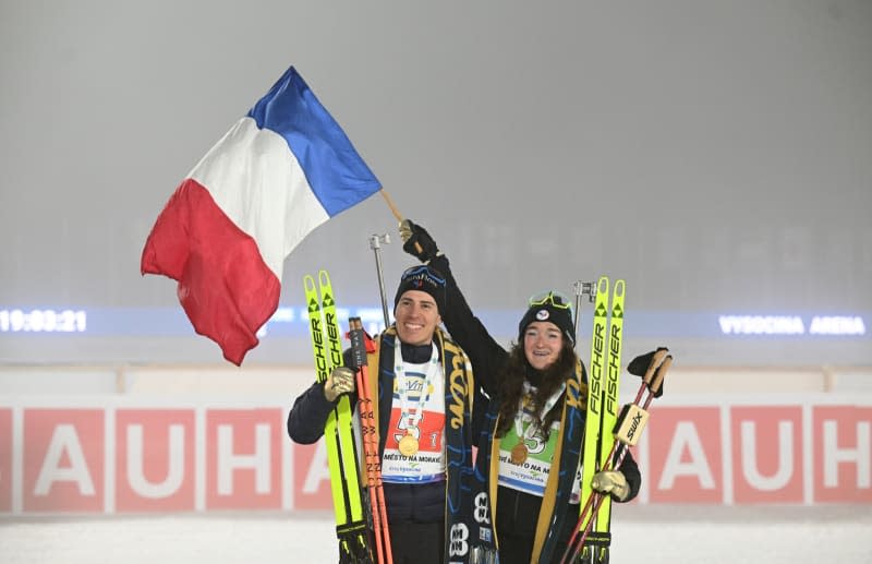 French biathletes Lou Jeanmonnot (R) and Quentin Fillon Maillet celebrate their first place after the award ceremony of the mixed individual relay of the Biathlon World Championships. Hendrik Schmidt/dpa