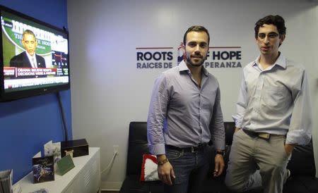 Felice Gorordo (L) and Raul Moas pose in their office in Miami Beach, Florida, December 19, 2014. REUTERS/Javier Galeano