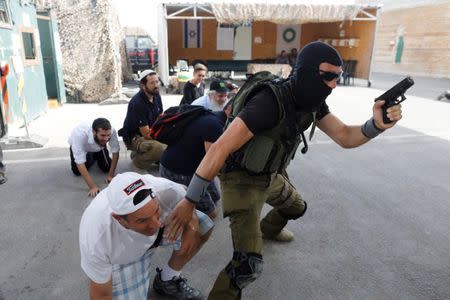 A group of tourists take part in a two hour "boot camp" experience, at "Caliber 3 Israeli Counter Terror and Security Academy " in the Gush Etzion settlement bloc south of Jerusalem in the occupied West Bank July 13, 2017. Picture taken July 13, 2017. REUTERS/Nir Elias