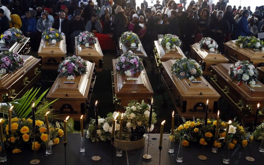 File - Coffins of 21 teenagers who died in a mysterious tragedy at a nightclub in the early hours of June 26, 2022 are lined up during their funeral held in Scenery Park, East London, South Africa, Wednesday, July 6, 2022. The toxic chemical methanol has been identified as a possible cause of the deaths of 21 teenagers at a bar in the South African city of East London last month, authorities said at press conference in East London Tuesday. July 19, 2022. (AP Photo/File)