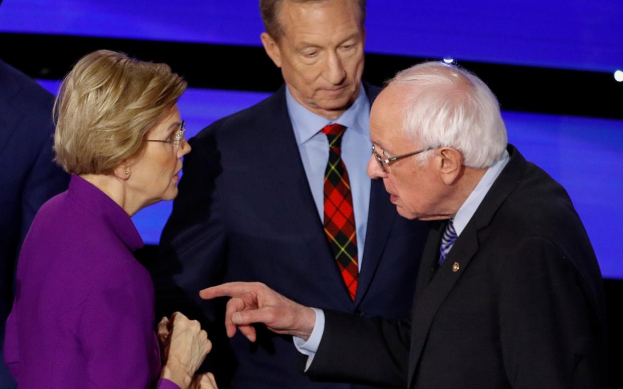 Democratic presidential candidate Sen. Elizabeth Warren and Sen. Bernie Sanders talk after the Democratic presidential primary debate  - AP