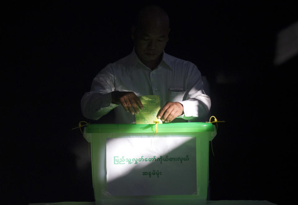 In this Saturday, Nov. 3, 2018, file photo, a voter casts his ballot at a polling station in Yangon, Myanmar. Myanmar staged by-elections Saturday in 13 constituencies, a few for the national parliament, the rest at the state or regional levels. (AP Photo/Thein Zaw, File)