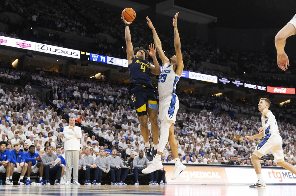 Marquette's Stevie Mitchell (4) shoots against Creighton's Trey Alexander (23) during the first half of an NCAA college basketball game Saturday, March 2, 2024, in Omaha, Neb. (AP Photo/Rebecca S. Gratz)