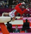 MEDAL RESHUFFLE AFTER FALL: A judge watches as Kohei Uchimura of Japan falls off the pommel horse during the men's gymnastics team final in the North Greenwich Arena during the London 2012 Olympic Games July 30, 2012.