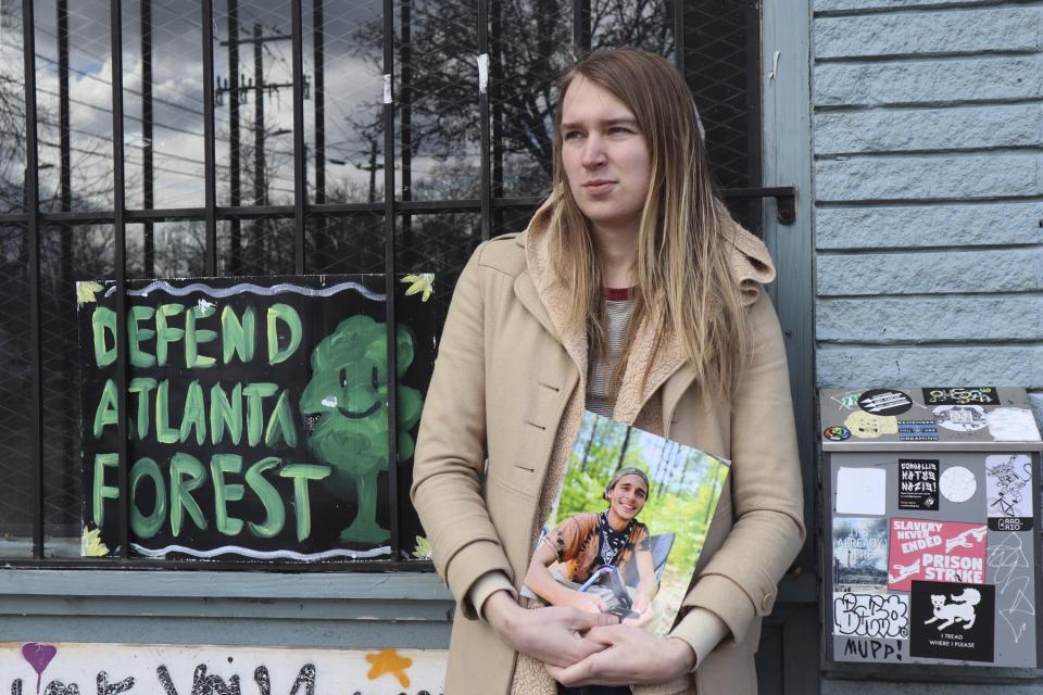 Vienna holds a photo of her slain partner, Tortuguita, in Atlanta on Thursday, Jan. 26, 2023. Officials have said officers fatally shot Tortuguita in self-defense after the protester shot a trooper on Wednesday, Jan. 18, but activists argue it was a state-sanctioned murder of a beloved community member who was renowned for having a big heart. (AP Photo/R.J. Rico)