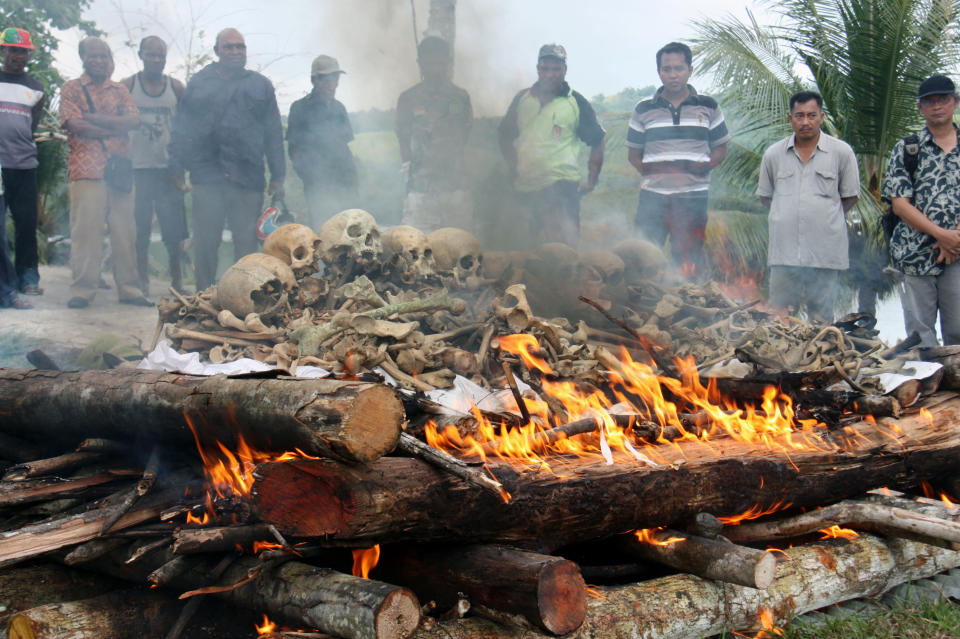 People gather for the cremation ceremony for Japanese war dead in World War II, in Papua province, Indonesia, March, 2013. Seventy-five years after the end of World War II, more than 1 million Japanese war dead are scattered throughout Asia, where the legacy of Japanese aggression still hampers recovery efforts. The missing Japanese make up about half of the 2.4 million soldiers who died overseas during Japan’s military rampage across Asia in the early 20th century. (Kyodo News via AP)